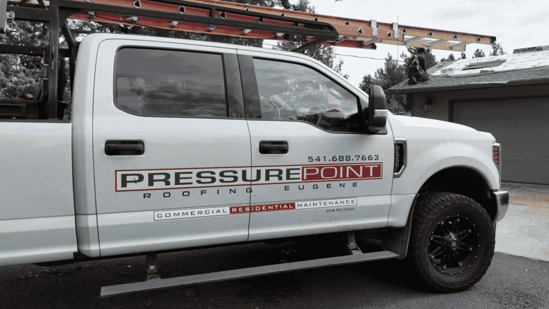 Roofing specialist from Pressure Point Roofing Eugene, LLC. reviewing wind damage on a coastal Florence, OR home for insurance claim documentation