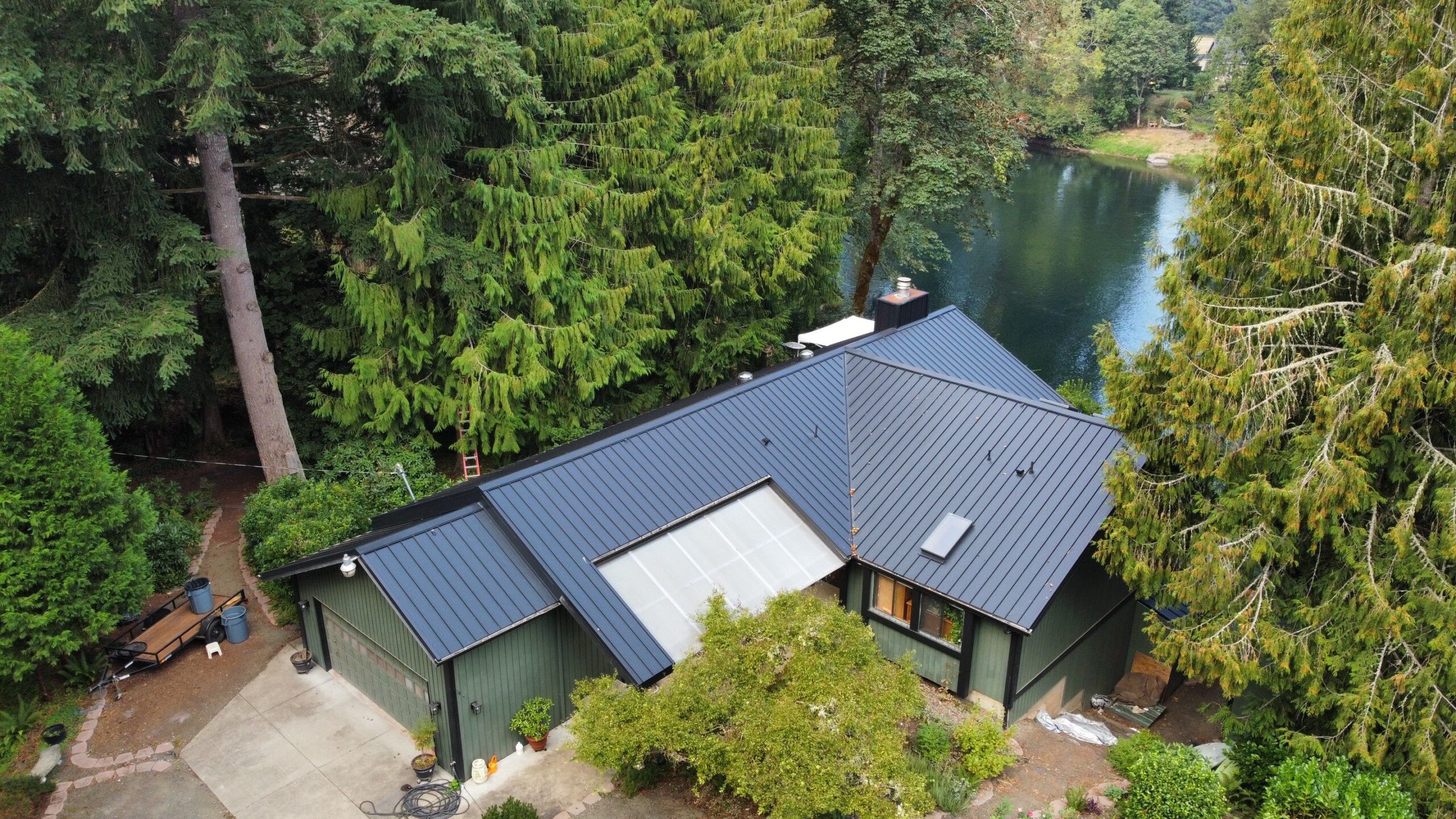 Roofing crew evaluating decking condition during complex residential roof replacement project