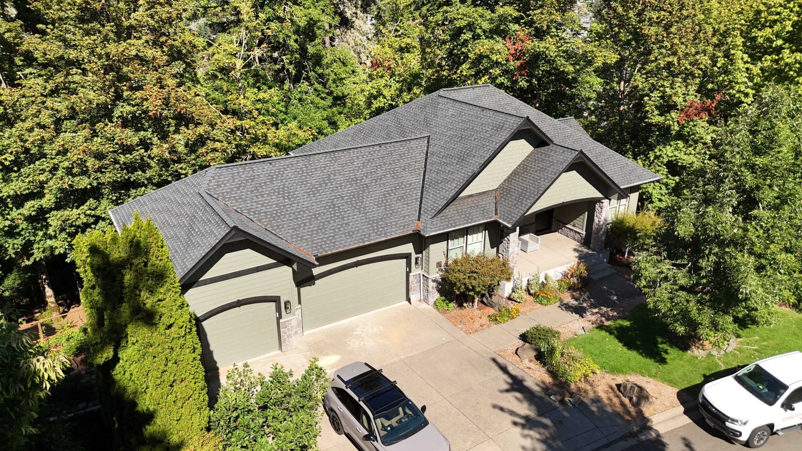 Roofing professionals inspecting decking and flashing during full roof replacement