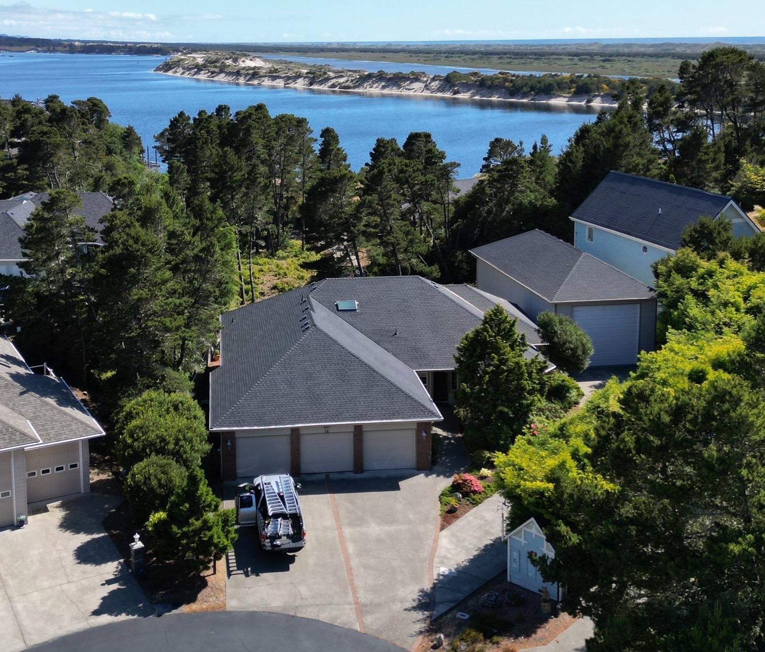 Crew installing replacement shingles on older Springfield residential roof